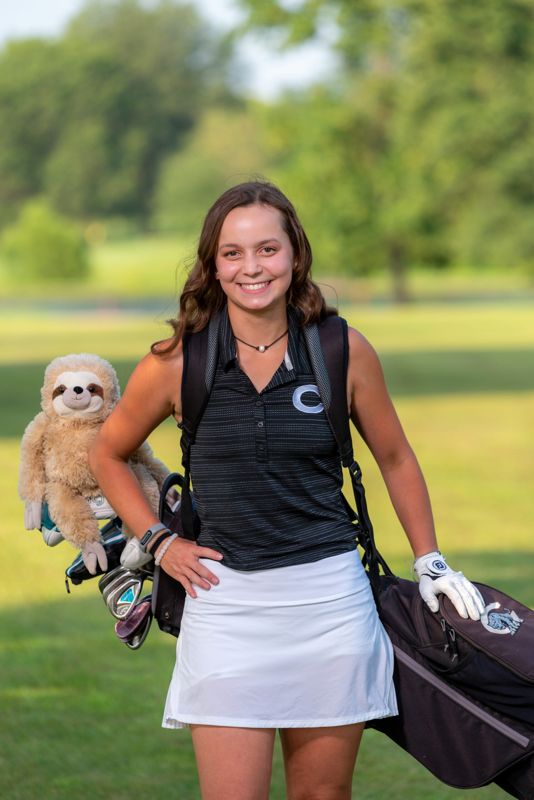 2022 Kennedy Dickerson female golfer holding up an award